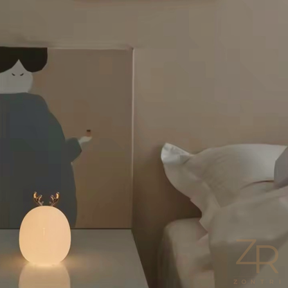 Warm glowing silicone rabbit night light on a bedside table.