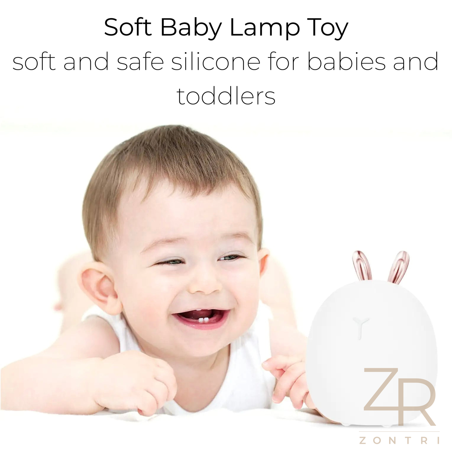 Smiling baby lying on a white background next to a soft silicone bunny (rabbit) night light branded by ZONTRI.